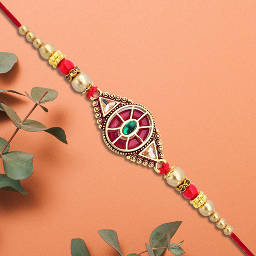 Superior eMar red and green enamel rakhi with gold beads and intricate decorative centerpiece