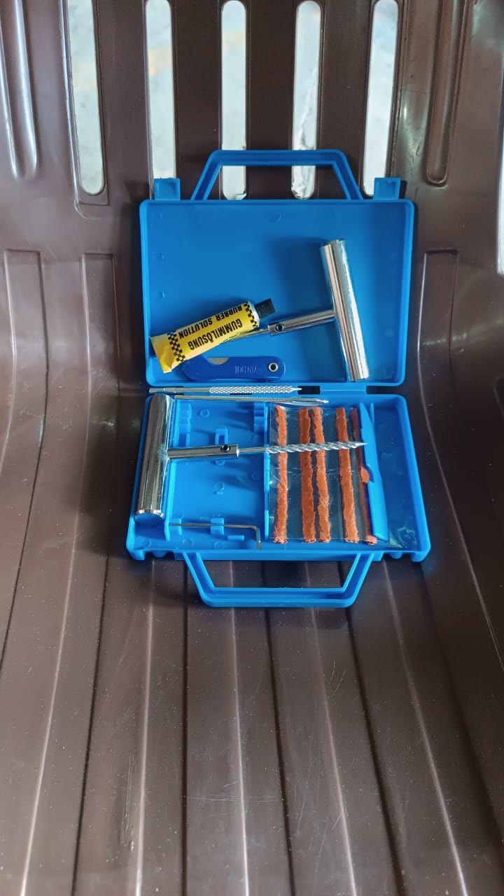 Blue tyre repairing tool set with various tools and rubber strips for automotive repairs