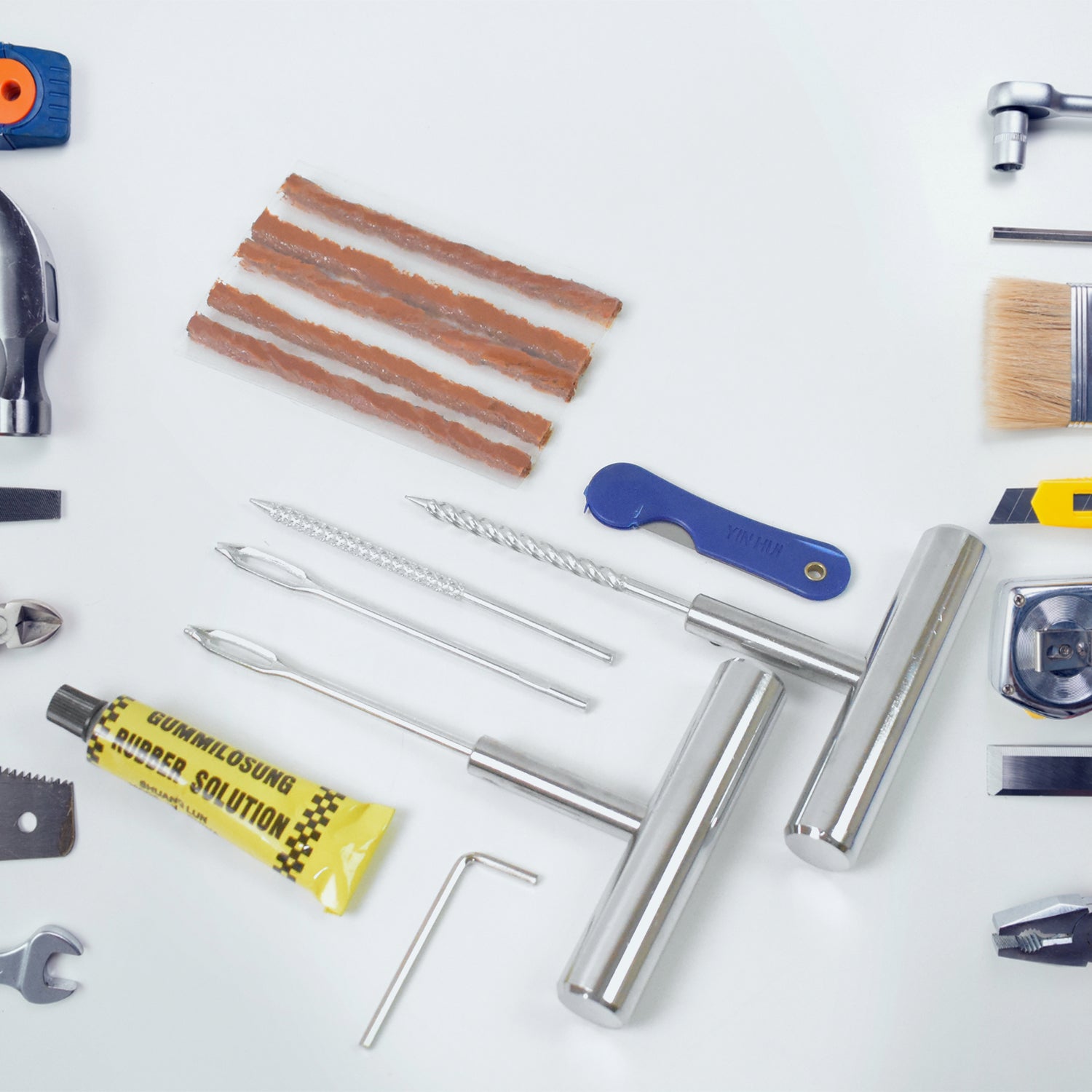 Comprehensive tyre repairing tool set including plugs, tools, and adhesives for efficient repairs