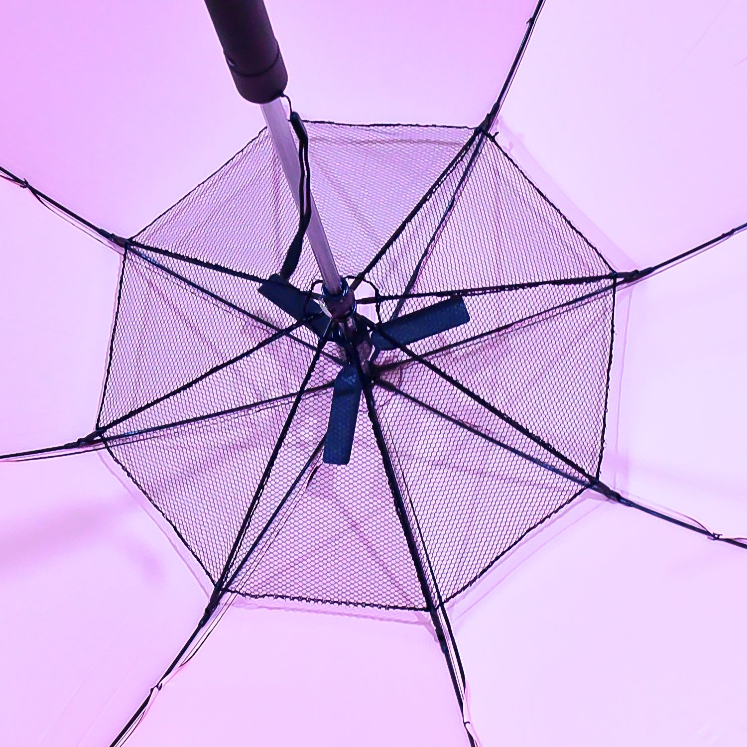 Inside view of an umbrella with built-in fan showing sturdy frame and mesh detailing