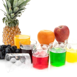 Colorful unbreakable drinking glasses set with assorted beverages and fresh fruits
