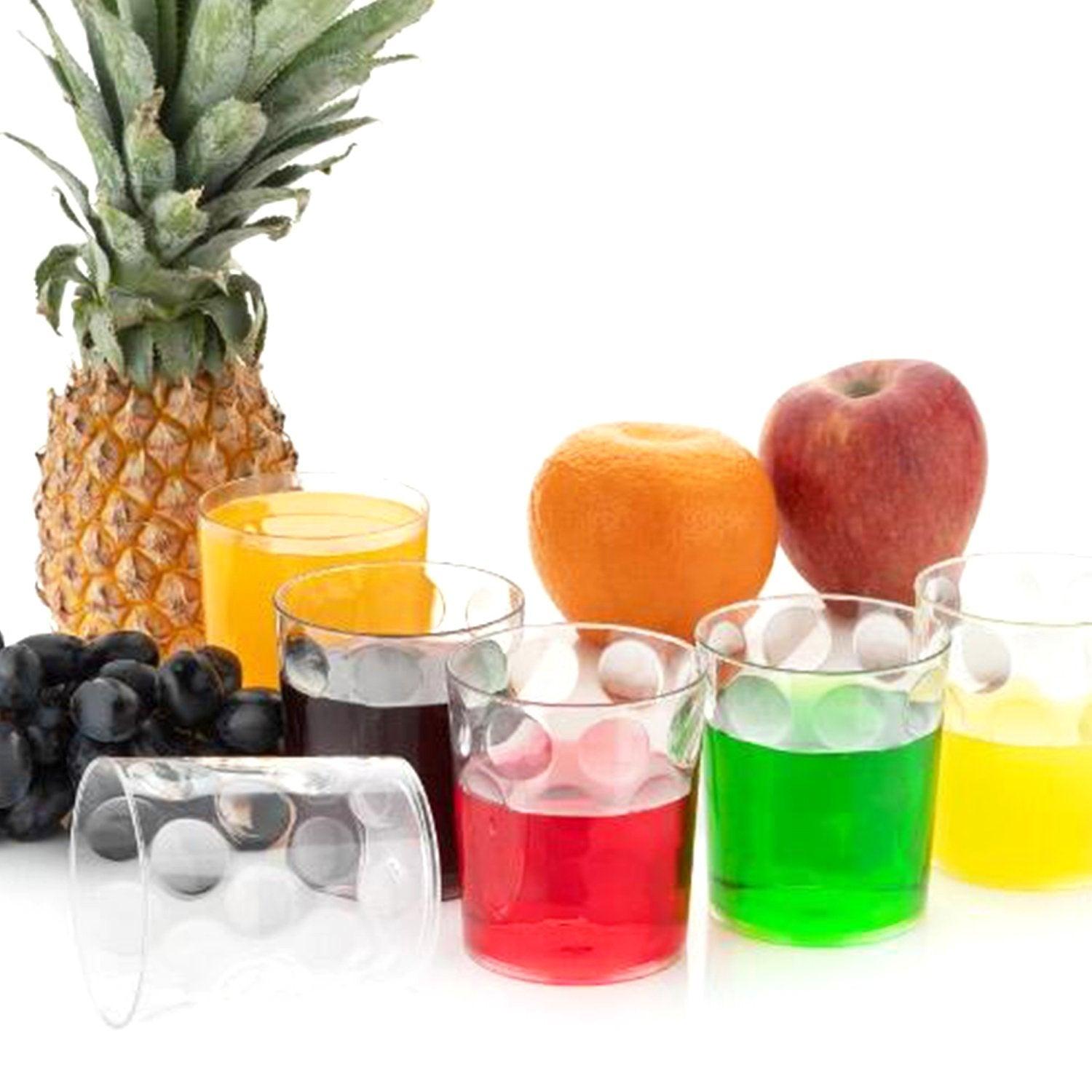 Colorful unbreakable drinking glasses set with assorted beverages and fresh fruits