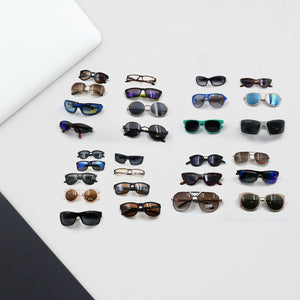 Variety of stylish UV protection sunglasses for men and women displayed on a surface