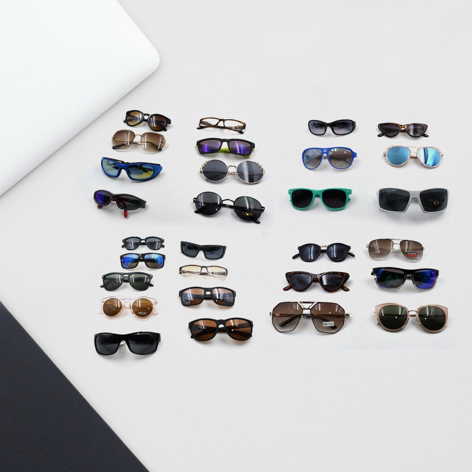 Variety of stylish UV protection sunglasses for men and women displayed on a surface