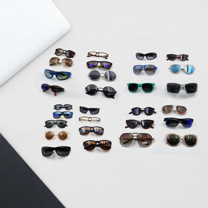 Variety of stylish UV protection sunglasses for men and women displayed on a surface