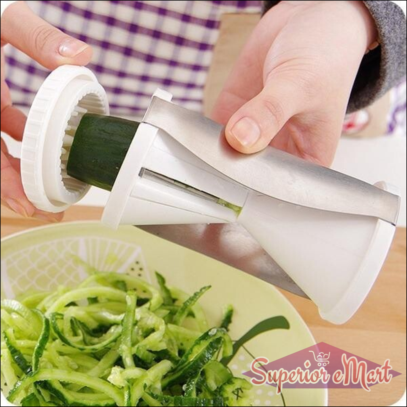 Superior eMart vegetable spiralizer slicer in use, creating spiralized cucumber noodles in a bowl