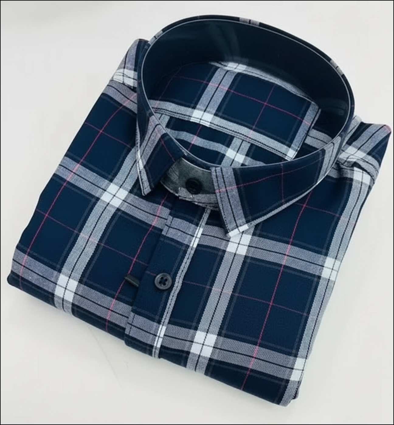 Folded plaid shirt on a white background