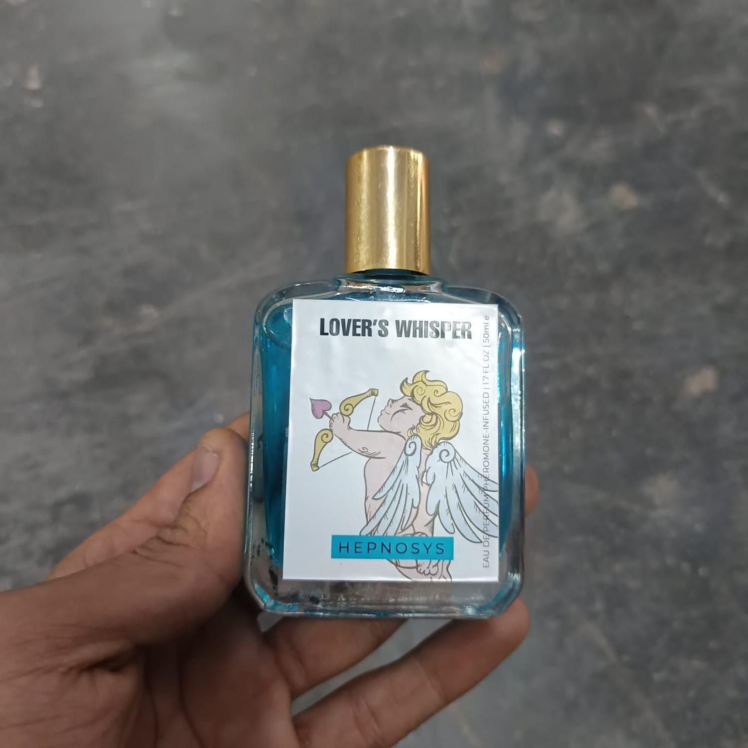 Hand holding Love's Whisper Perfume 50ML with Cupid design and gold cap by Superior eMart