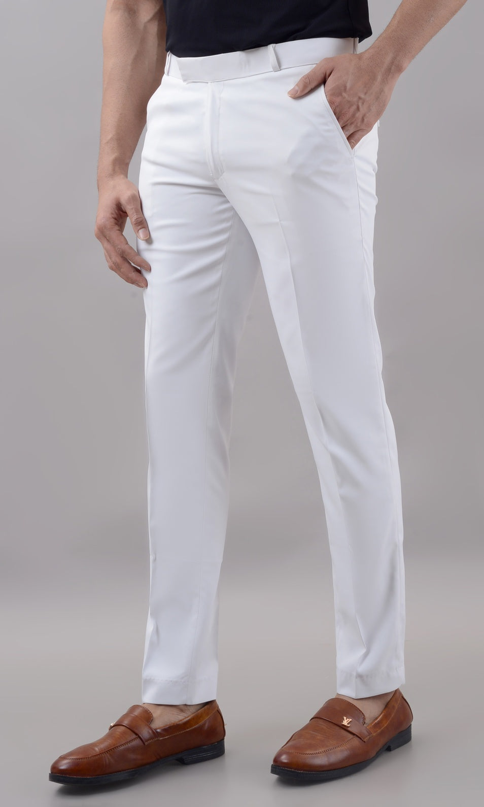 Person wearing white pants with a plain background