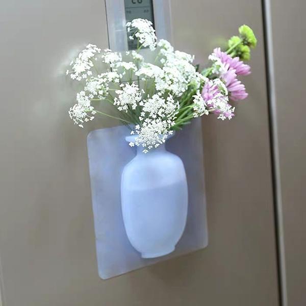 Wall mounted flower pot sticker with a sleek design, holding fresh flowers on a refrigerator door