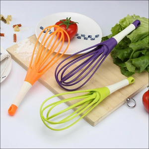 Set of colorful silicone balloon whisk mixers for kitchen in orange, purple, and green for easy mixing