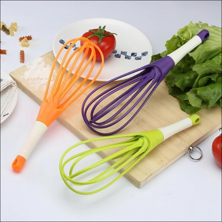 Set of colorful silicone balloon whisk mixers for kitchen in orange, purple, and green for easy mixing