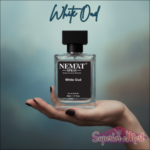 Hand holding Nemat White Oud 1.7 fl.oz spray perfume in a clear glass bottle with a black label and square cap.