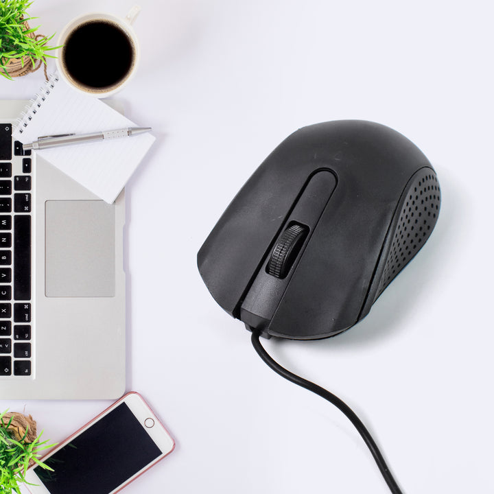 Wired optical mouse M-022 in black placed next to a laptop and a coffee cup