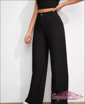 Person wearing black high-waisted pants on a white background
