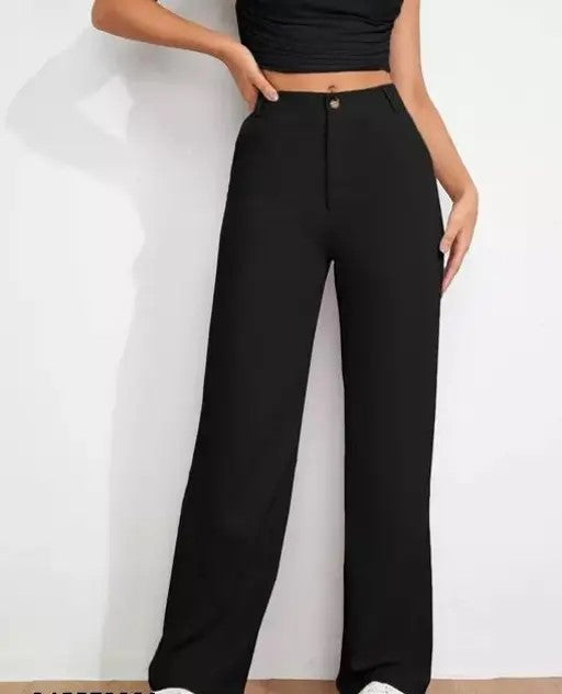 Black high-waisted pants worn by a person on a white background