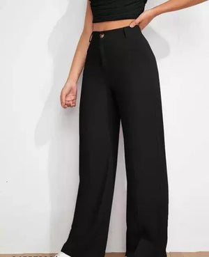 Person wearing black high-waisted pants on a white background