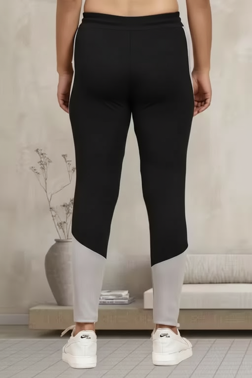 Back view of women's multicolor jeggings featuring black and gray colorblock design for comfort and style