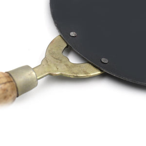 Close-up of wooden handle roti tawa with metal base for perfect cooking and even heat distribution