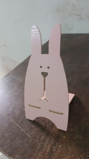 Wooden rabbit phone stand with a cute design for holding smartphones securely