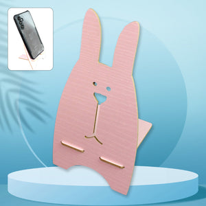 Wooden rabbit phone stand in pink designed for easy device viewing and stability