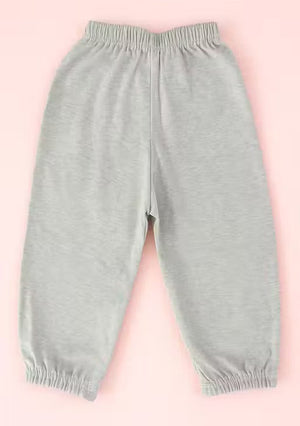 Light gray heathered jogger pants with an elastic waistband and elastic cuffs, laid flat on a solid pink background.